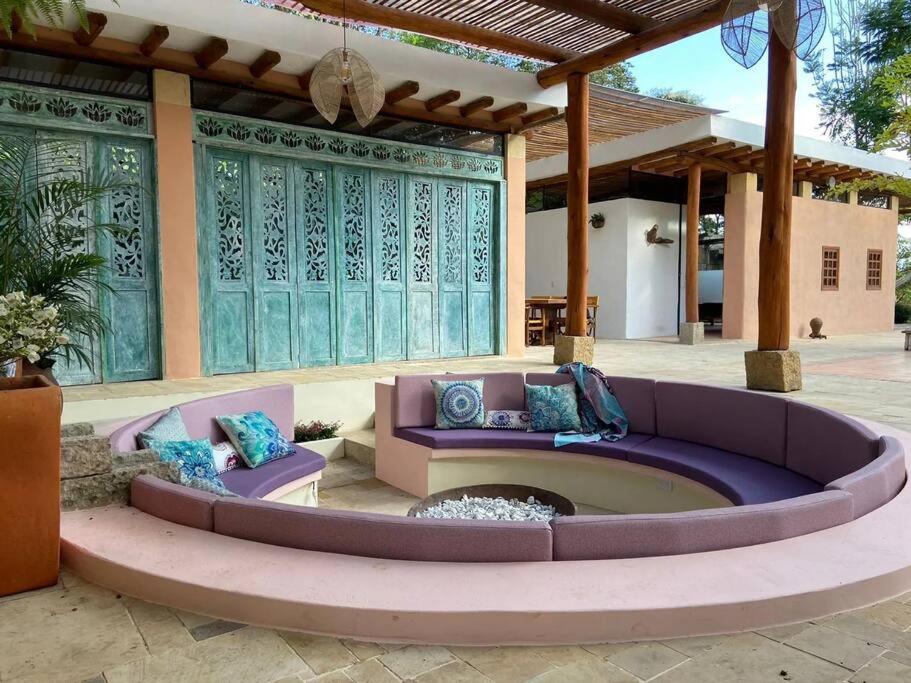 a patio with two couches and a fire pit at Casa descanso familiar Silvania in Silvania