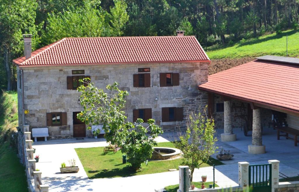 a large stone house with a red roof at Casa Faustino in A Coruña