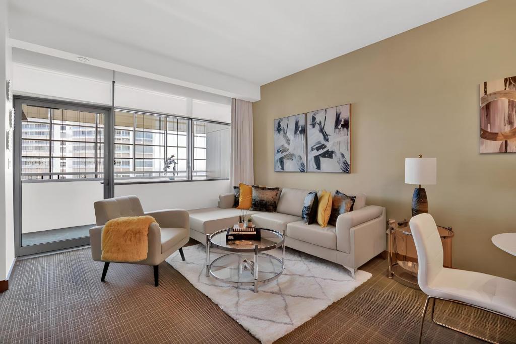 a living room with a couch and a table at Brickell Bliss - Luxury Condo in Miami