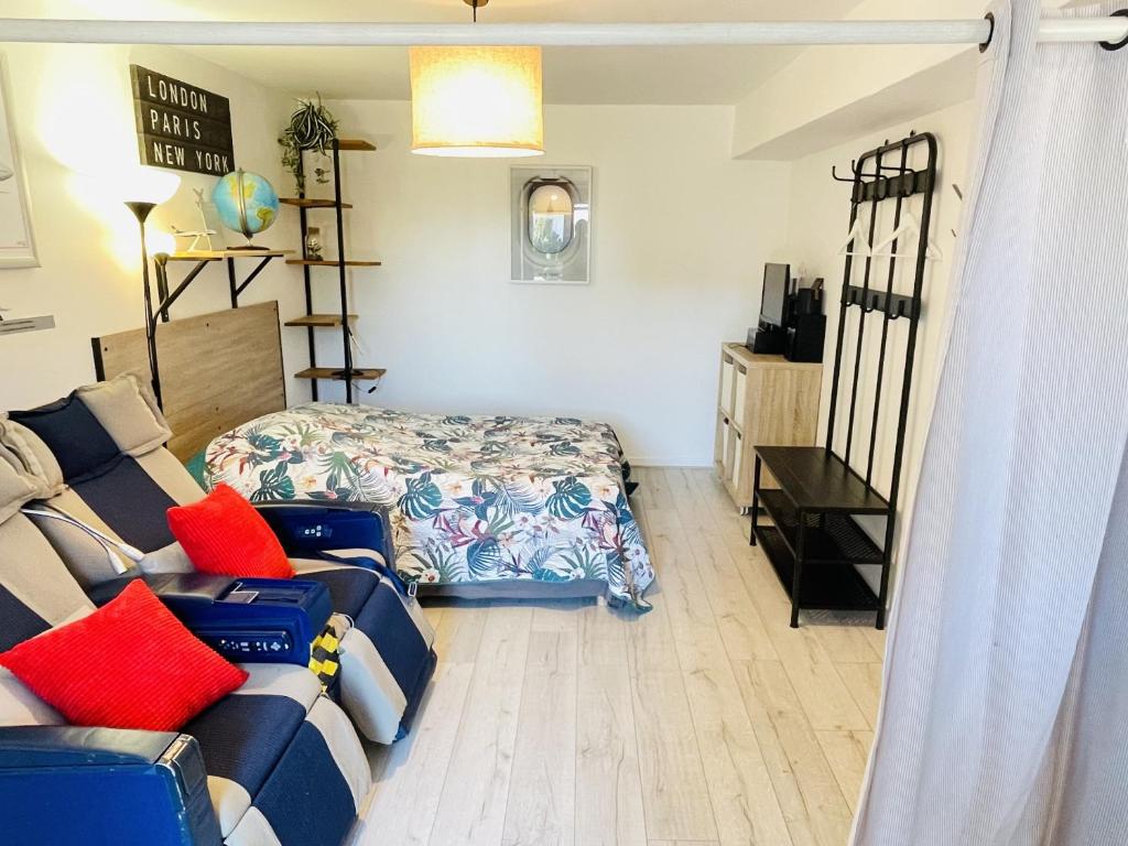 a living room with a couch and a bed at Gite du Moulin in Saint-Laurent-dʼAndenay