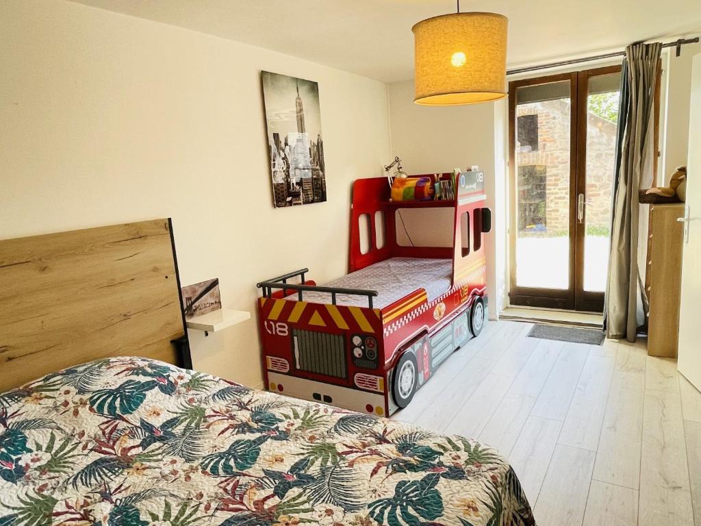 a bedroom with a bed and a truck bed at Gite du Moulin in Saint-Laurent-dʼAndenay