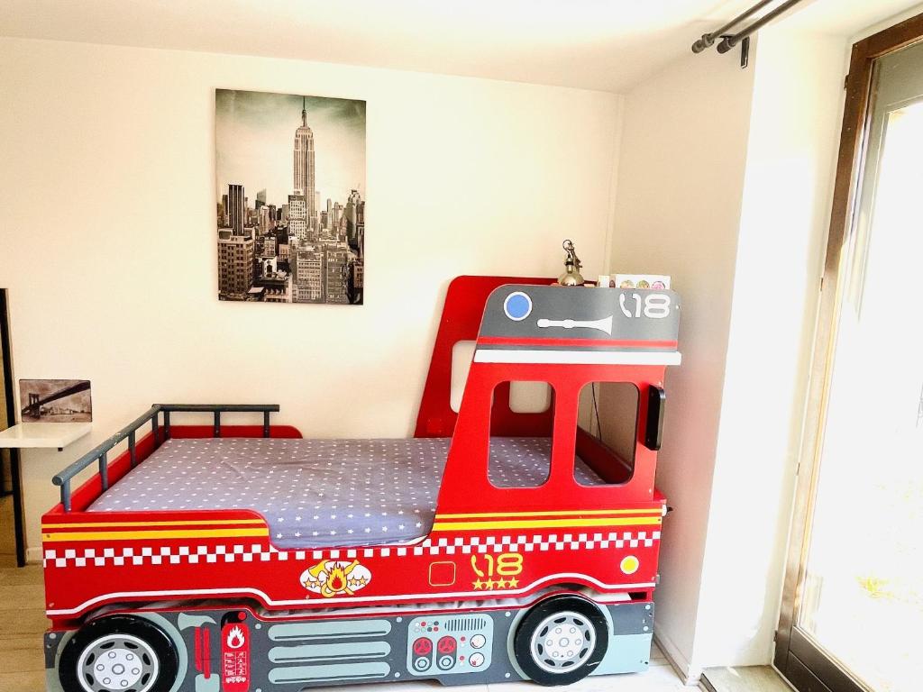a bedroom with a fire truck bed in a room at Gite du Moulin in Saint-Laurent-dʼAndenay