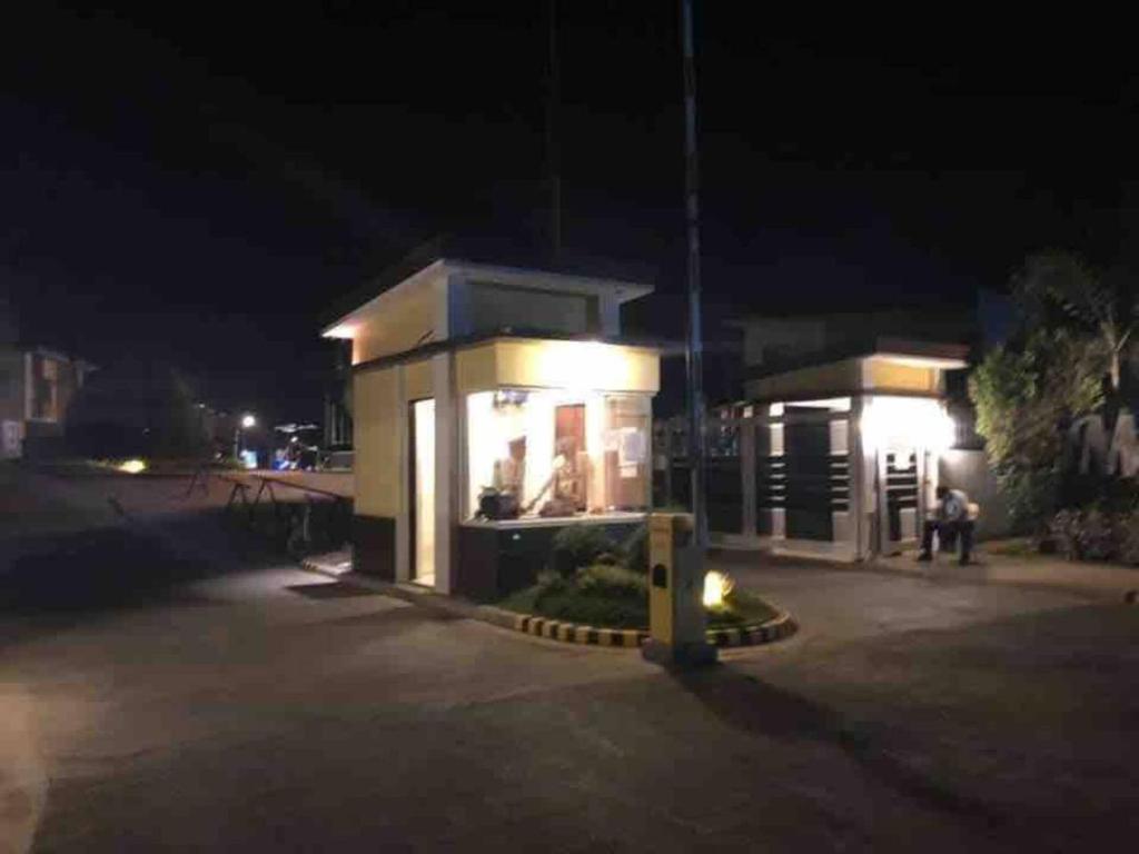 a gas station at night with people sitting outside at 3 Bedroom Furnished House near SM CDO uptown in Cagayan de Oro