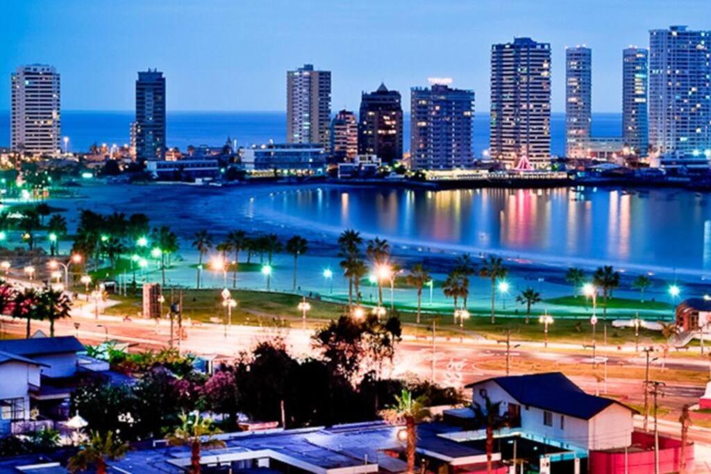 a city skyline at night with a large body of water at APARTAMENT IN PENINSULA IQUIQUE(NEAR OF ALL) in Iquique