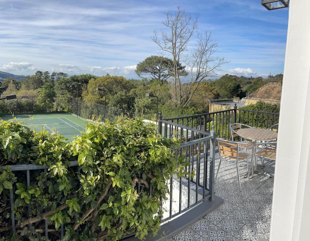 a view of a tennis court from a balcony at Chez Botanica Apartment Constantia in Cape Town