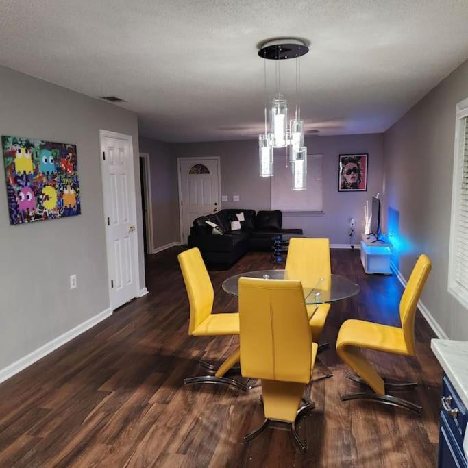 a living room with a table and yellow chairs at Totally Rad Pad! in Midway
