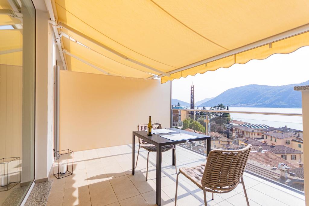 uma varanda com uma mesa e cadeiras e uma vista em Casa Elea_ Panoramic Attic in City Center em Campione dʼItalia