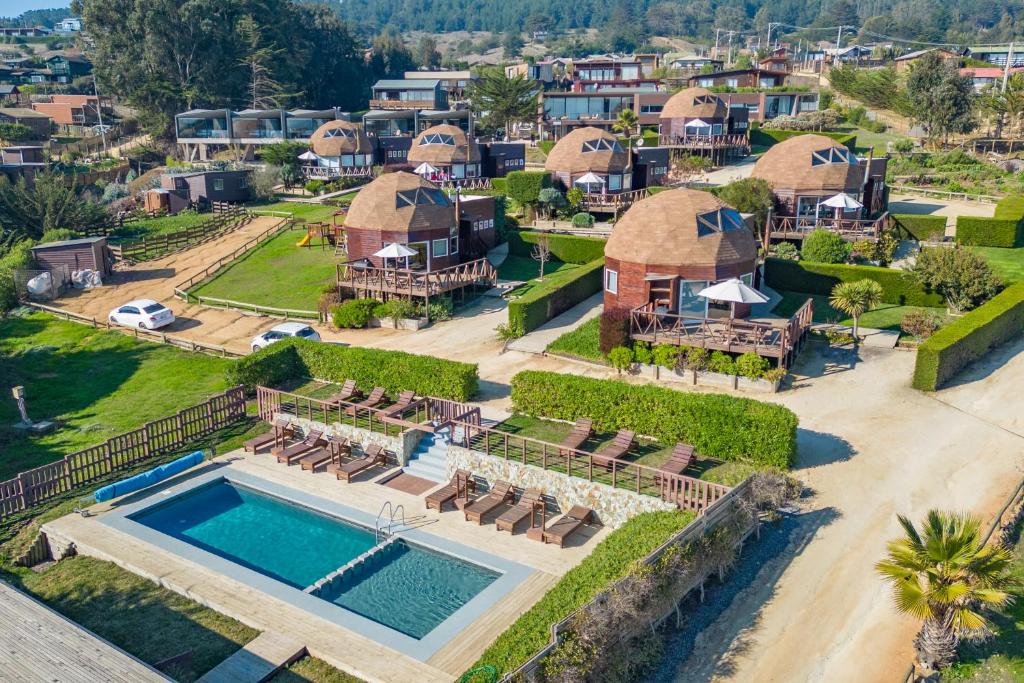 an aerial view of a villa with a swimming pool and a resort at Pichilemu Domos in Pichilemu