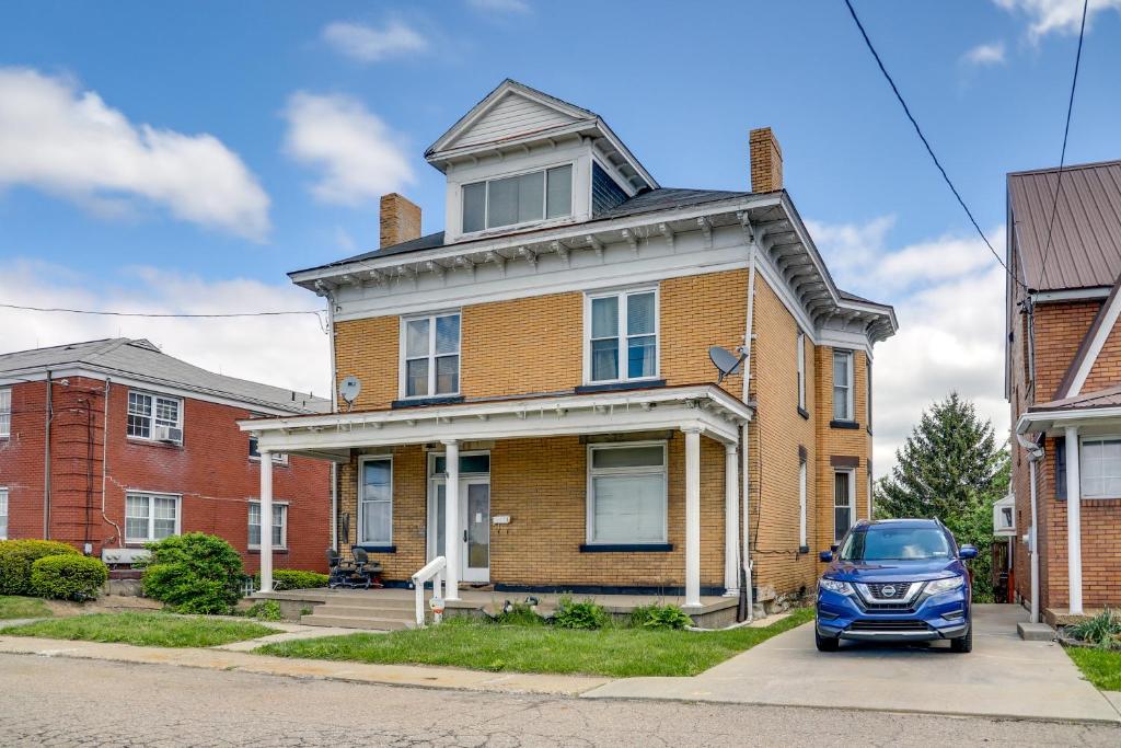 a blue car parked in front of a brick house at Pittsburgh Vacation Rental about 6 Mi to Downtown! in Pittsburgh