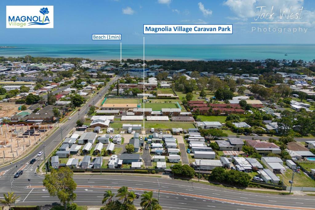 an aerial view of a city with a parking lot at Magnolia Village Caravan Park in Hervey Bay