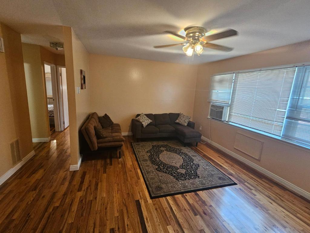a living room with a couch and a ceiling fan at 1st floor Private Apt near Ferry to NYC and Park in Tompkinsville