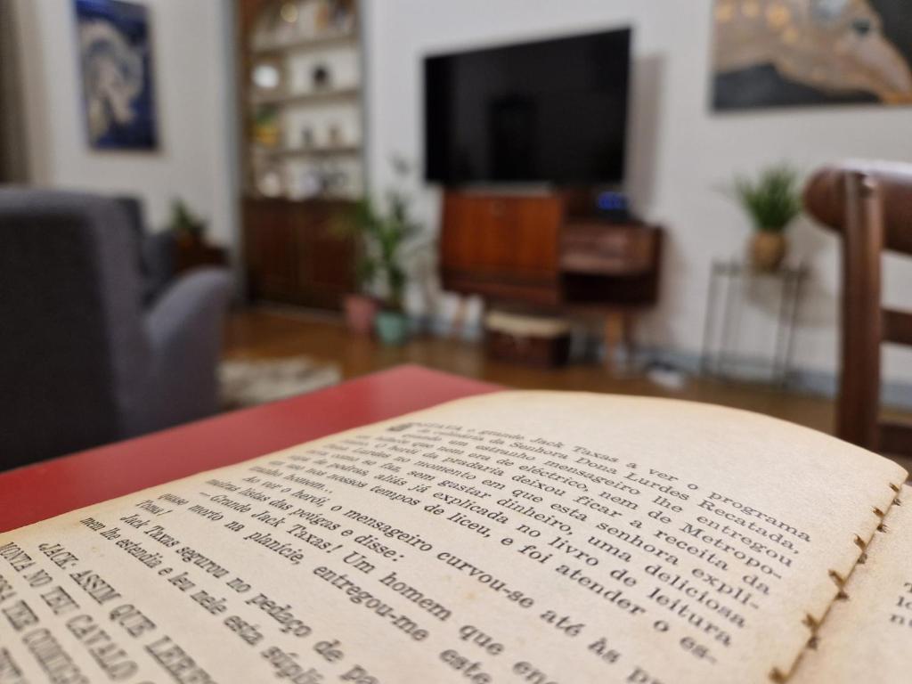 an open book sitting on a table in a living room at Mont' Sobro House in Évora
