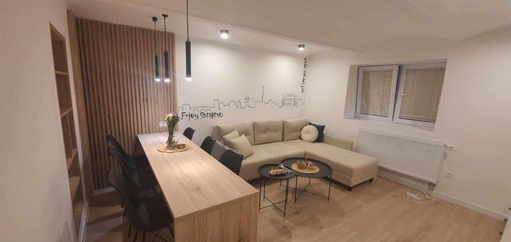 a living room with a couch and a table at Urban Den in Sarajevo