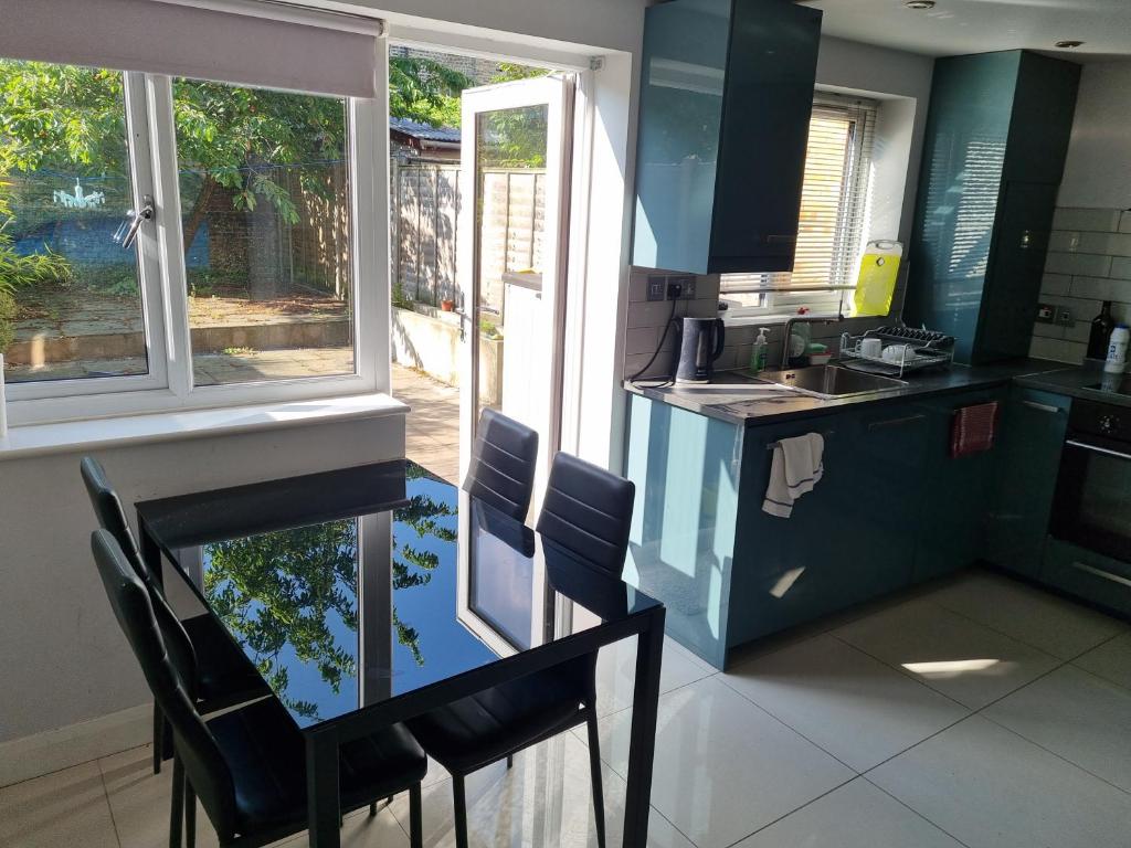 a kitchen with a table and chairs and a counter top at Single room with en-suite shower room in Zone 1 London in London