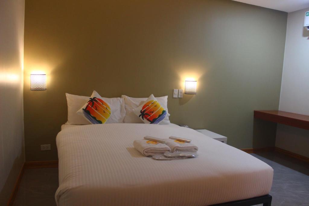 Postel nebo postele na pokoji v ubytování NGN Gran Hotel