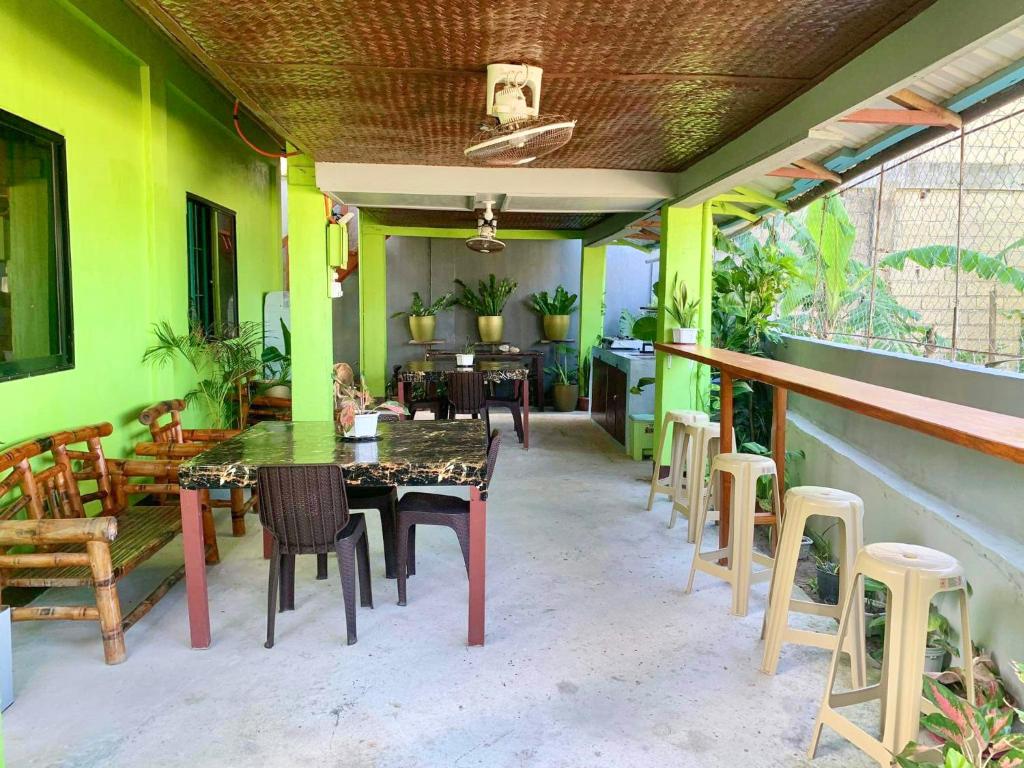 a dining room with green walls and a table and chairs at Selim Guesthouse in San Vicente