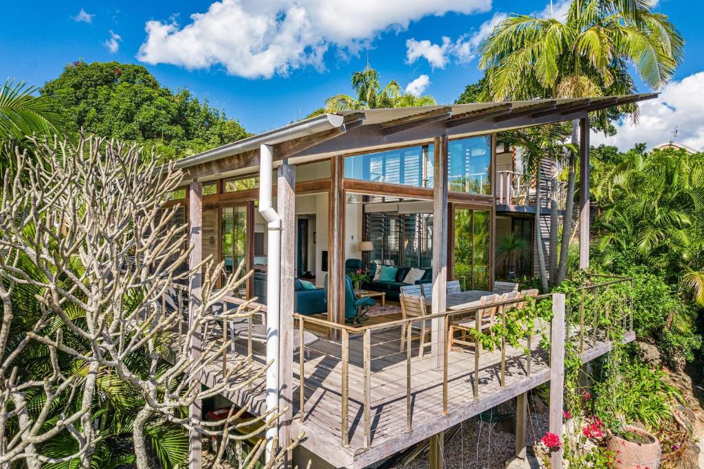 a home on the beach with a wrap around deck at Above The Pass in Byron Bay