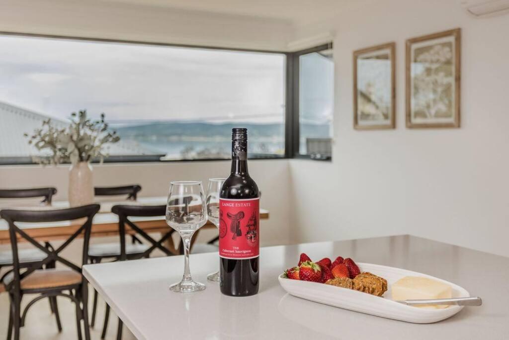 Albany的住宿－Vancouver Vista，桌子上放着一瓶葡萄酒和一盘草莓