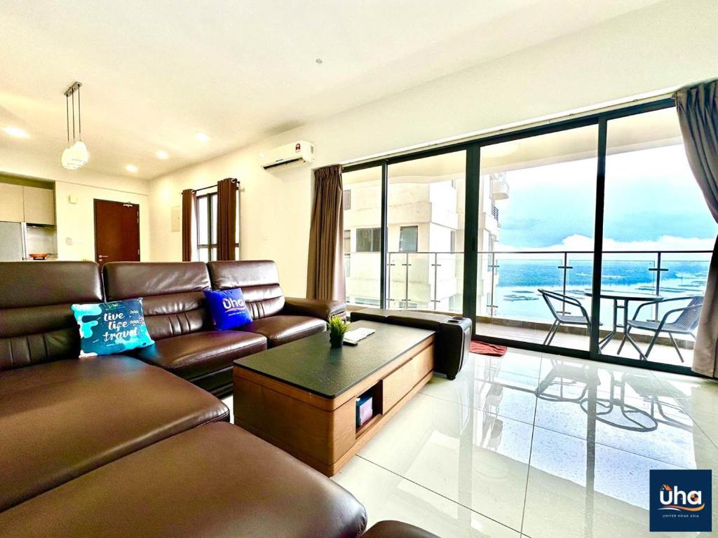 a living room with a couch and a view of the ocean at Country Garden Danga Bay @ UHA in Johor Bahru