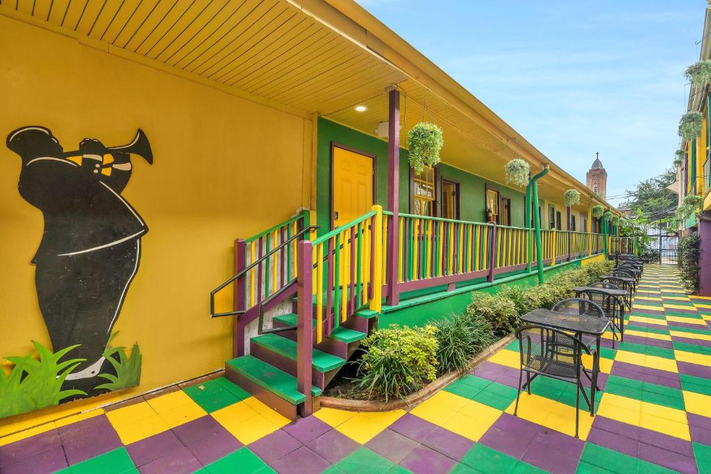 a building with colorful floors and stairs on a street at Historic Mardi Gras Inn in New Orleans