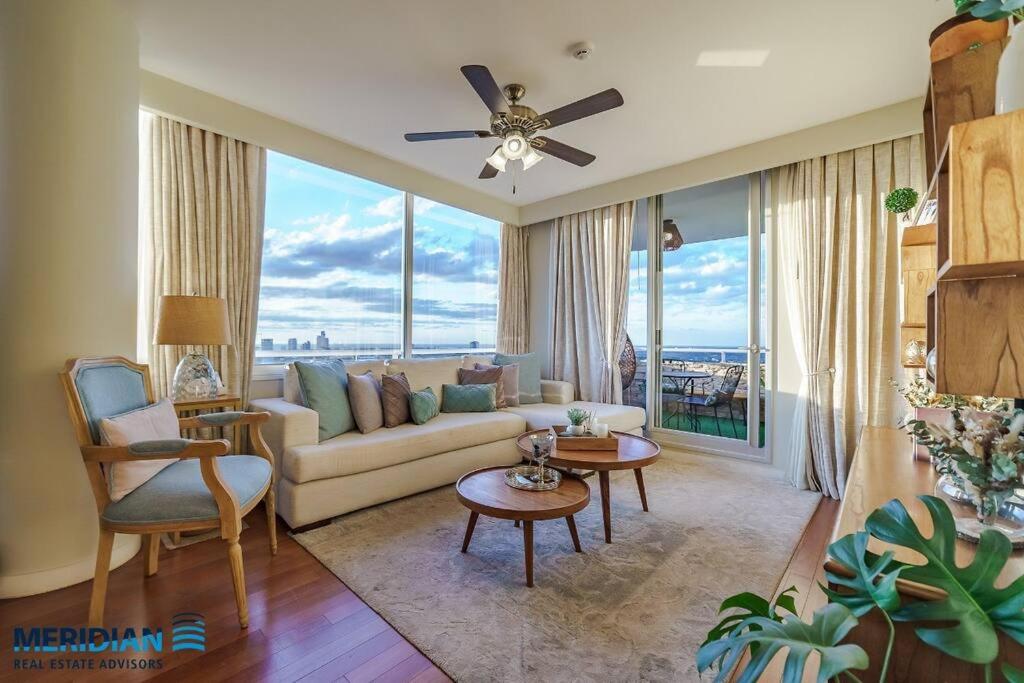 a living room with a couch and a large window at Gorgeous Apartment in Asunción in Asunción