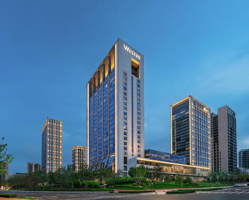 a tall building in the middle of a city at The Westin Yantai in Yantai
