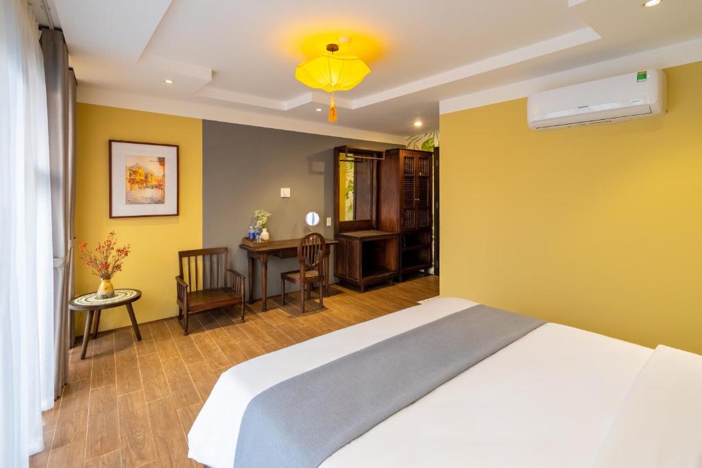 Postel nebo postele na pokoji v ubytování Hoianan Boutique Hotel
