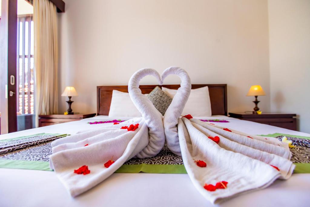 Postel nebo postele na pokoji v ubytování Lili Cottage Ubud