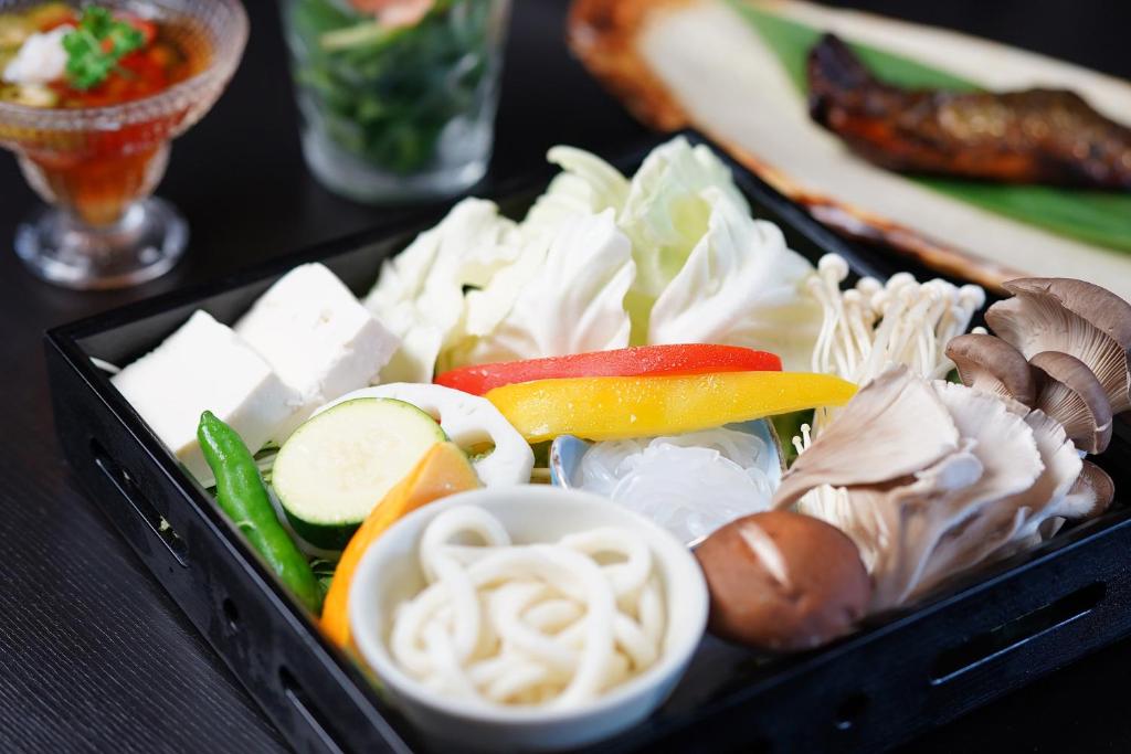a black tray filled with different types of food at Ikariya Ryokan in Yamanouchi