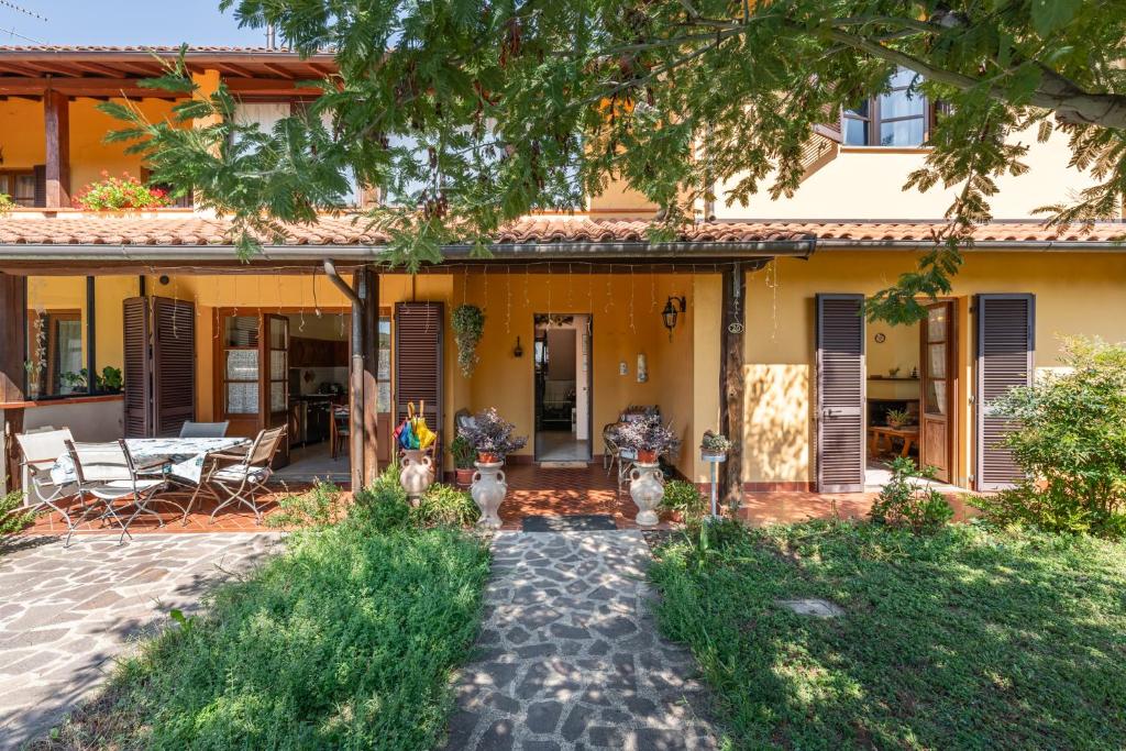 a yellow house with a patio in front of it at Casa di Nonna Adriana in Pieve Fosciana