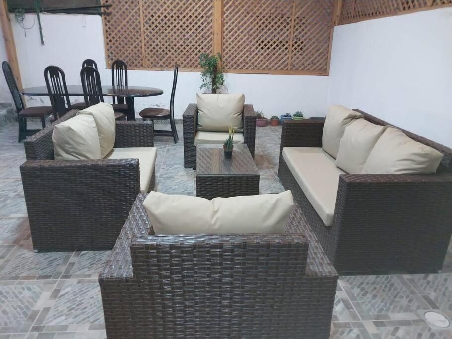 a living room with wicker furniture and a table at Adam's Apartment in Amman