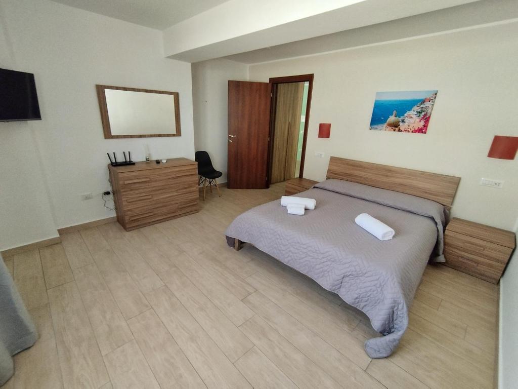 a bedroom with a bed and a dresser in it at La Penisola in Santa Maria La Carità