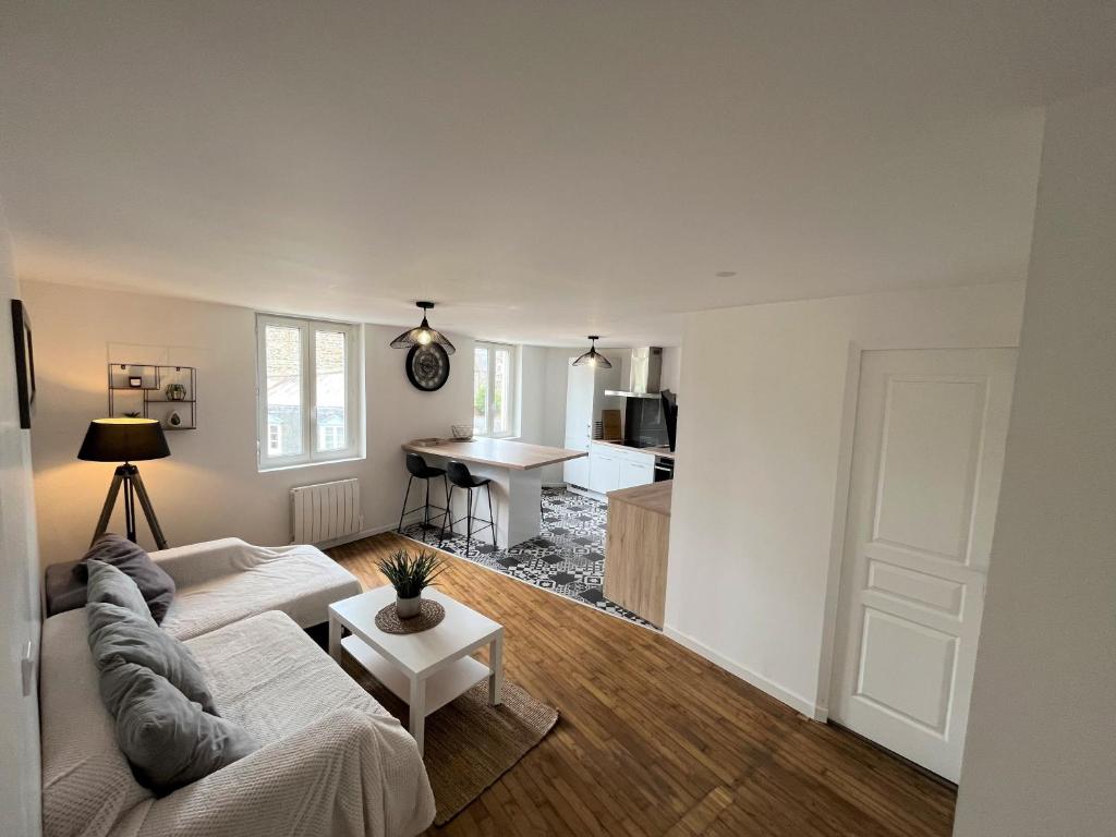 a living room with a couch and a table at Coeur de ville , 70m2 , 2 chambres in Saint-Brieuc