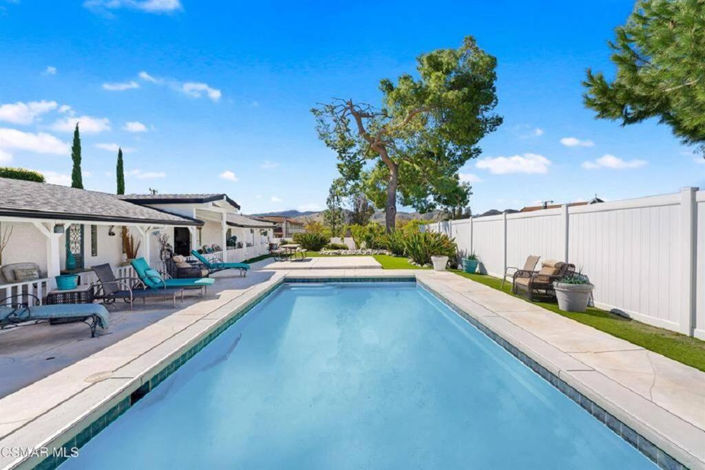 a swimming pool in the backyard of a house at 4 bed 3 bath pool house gated property in Thousand Oaks