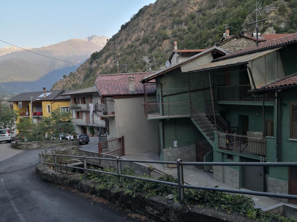 a street in a town with houses and a mountain at Appartamenti Rio Geandola 