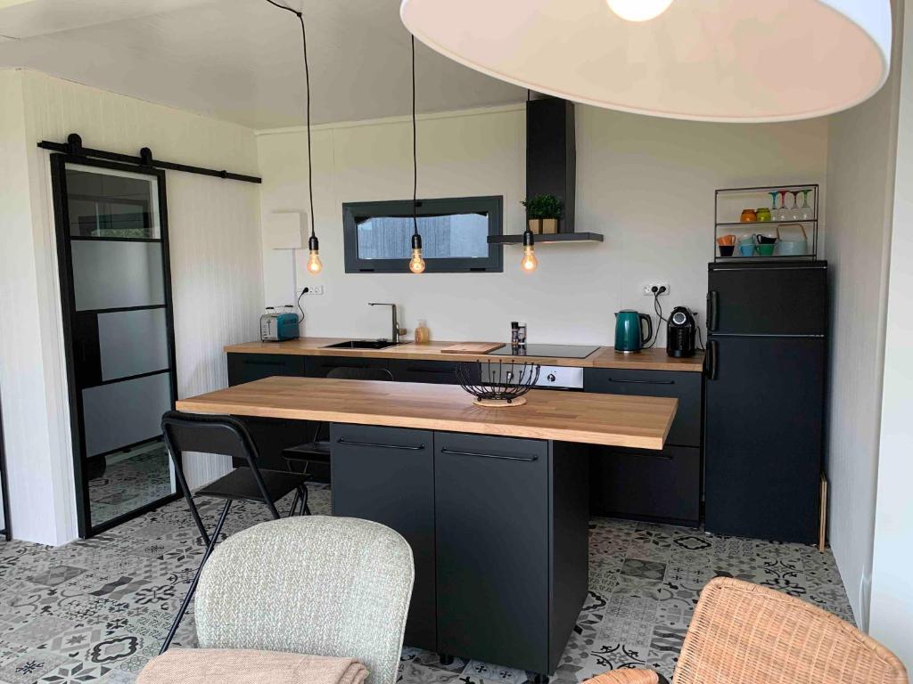a kitchen with a table and two chairs and a refrigerator at Montinho Boutique Studio in Benagil