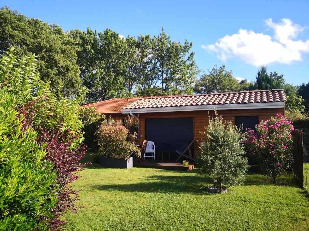 uma pequena casa num jardim com relvado em Entre terre et mer em Sainte-Eulalie-en-Born