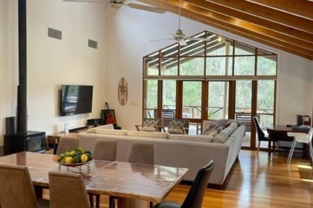 a living room with a couch and a table at Pine View Cottage - Margaret River in Cowaramup