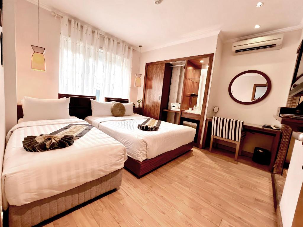 Postel nebo postele na pokoji v ubytování Elite Central Hotel Hanoi