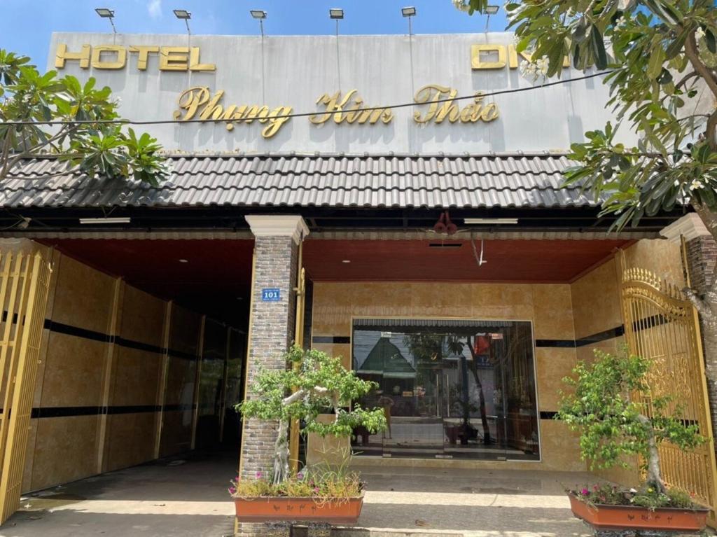 a hotel with a sign on the front of a building at Phụng Kim Thảo Hotel Long An in Long An