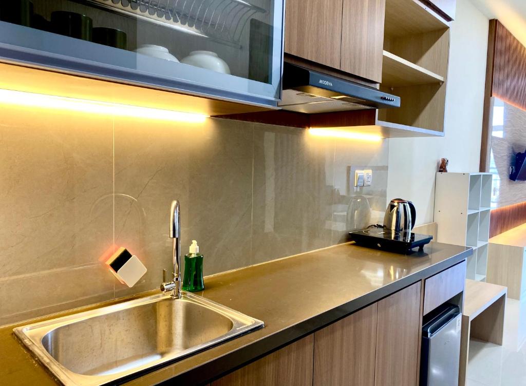 a kitchen with a stainless steel sink and a counter at PREMIER RESIDENCES @Formosa Residence Nagoya in Nagoya