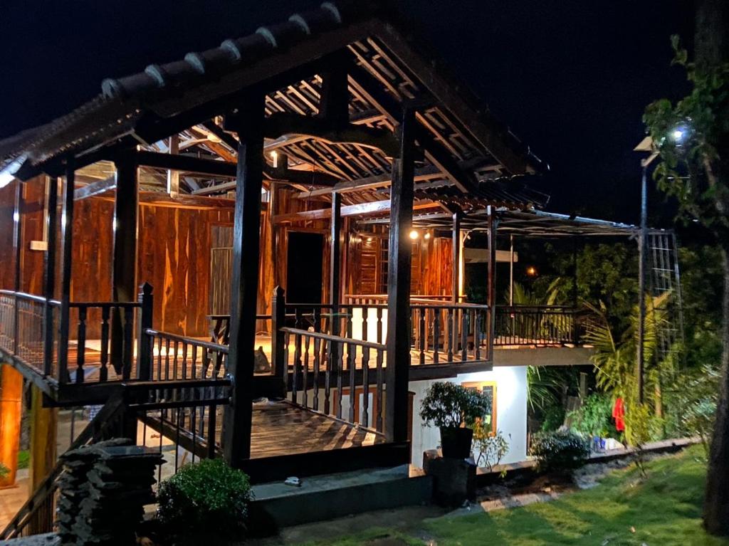 a house with a large deck at night at Highland Vân Hòa Phú Yên in Tuy Hoa