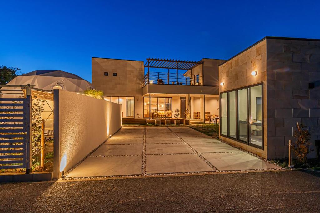 a large house with a fence in front of it at Innocence Resort -in Chiba Resol- in Hasunuma