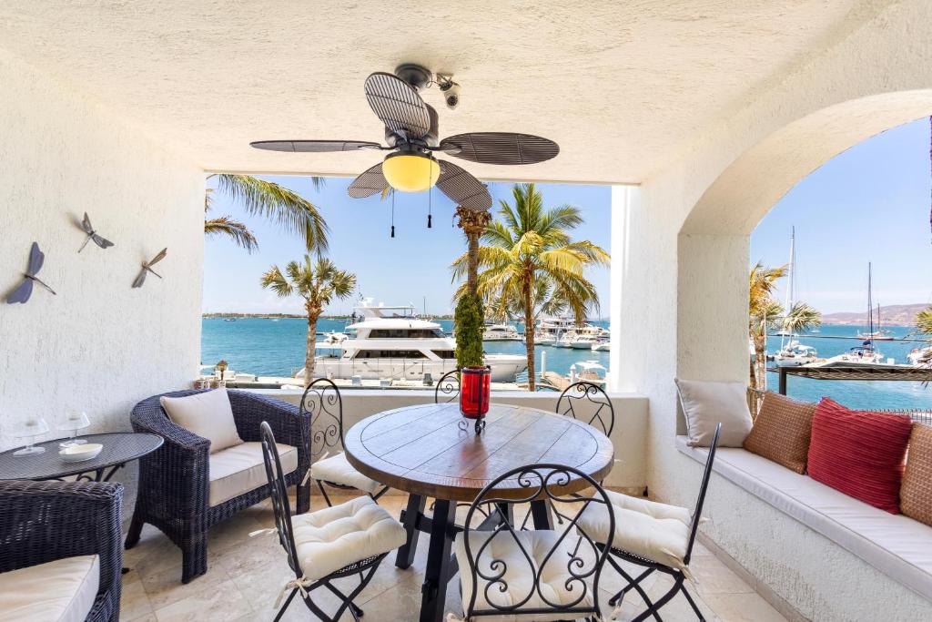 a dining room with a table and chairs and the ocean at The OceanFront Private Residence in La Paz