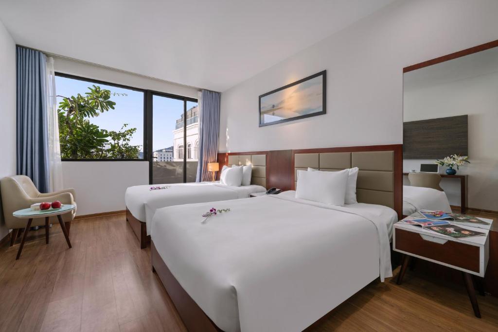 Postel nebo postele na pokoji v ubytování Aria Grand Hotel & Spa