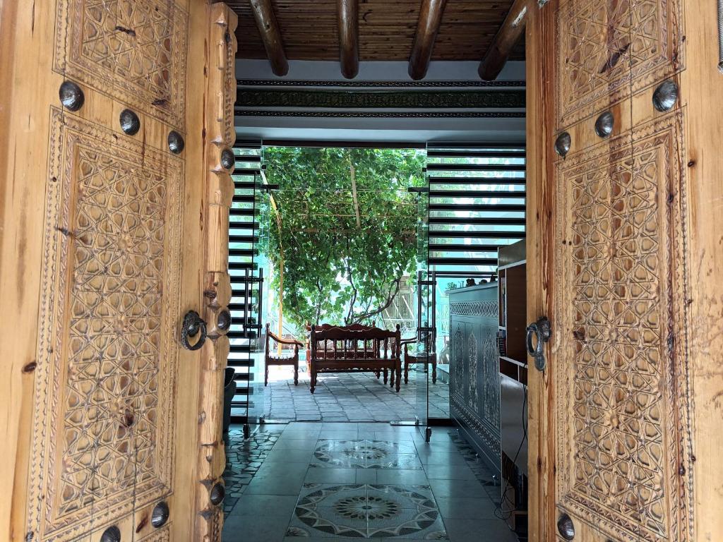 an open door to a patio with a table at Samani Bukhara in Bukhara