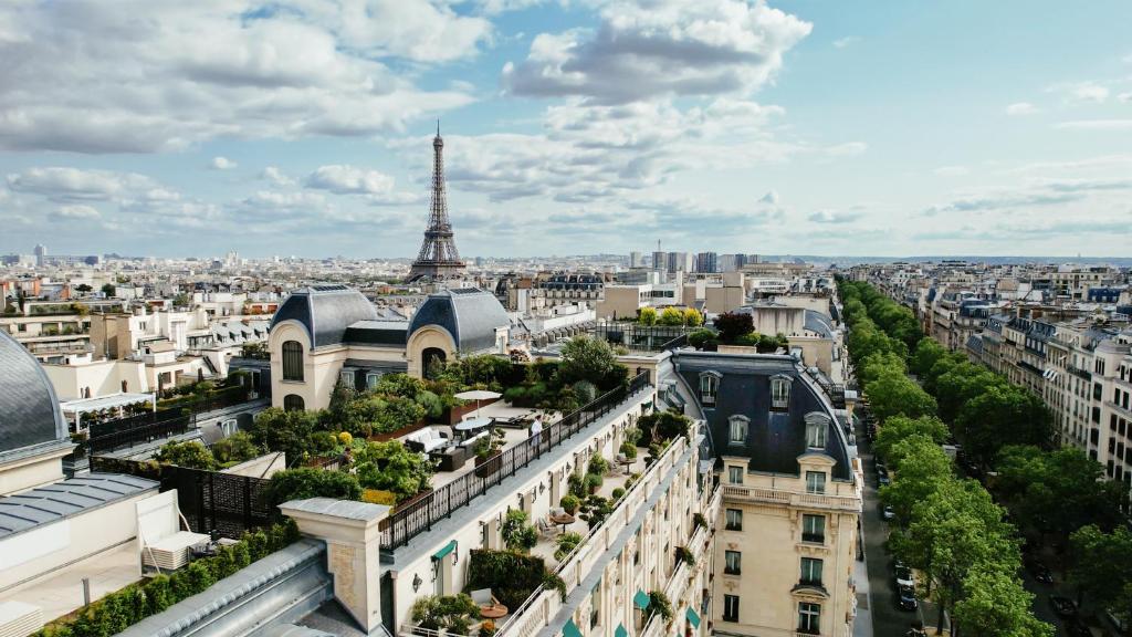 a view of the city of paris with the eiffel tower at Hotel The Peninsula Paris in Paris