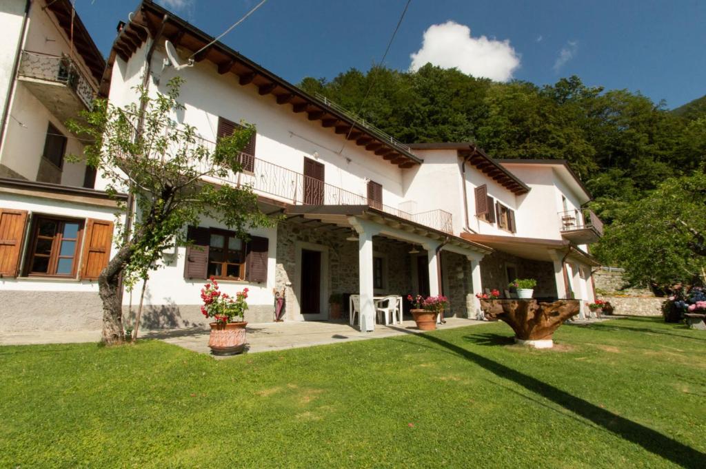 a large white house with a yard at B&B La Bredia in Fivizzano