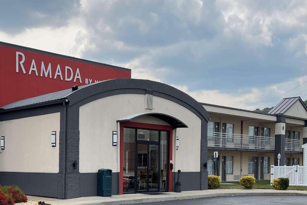 a building with a red door in front of a building at Ramada by Wyndham Harrisonburg in Harrisonburg
