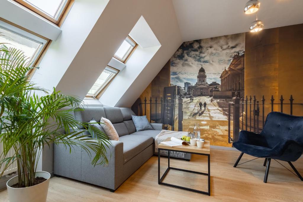 a living room with a couch and a wall mural at Apartament 24 AbsyntApart Rynek Wrocław - MAMY WOLNE POKOJE ! in Wrocław